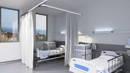 Enfermaria de Hospital onde se pode visualizar duas camas e as janelas.