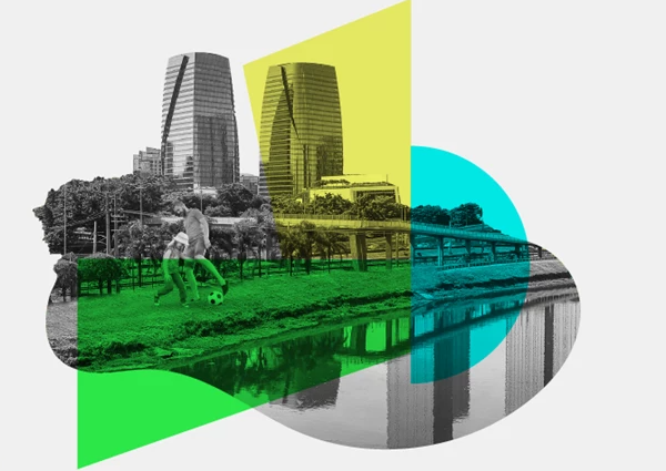 Dois edifícios altos com parque urbano e duas pessoas (adulto e criança) a jogar à bola.